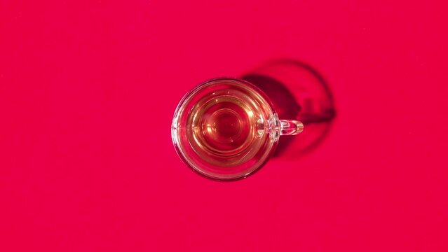 Cup fills with tea in stop motion