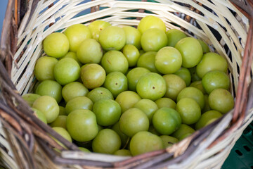 Green turkish plum can erik in basket