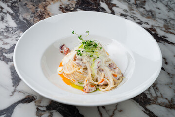 Italian food pasta with bacon, cream sauce and microgreens.