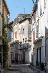 Fototapeta na wymiar View on old streets and houses in ancient french town Arles, touristic destination Roman ruines, Bouches-du-Rhone