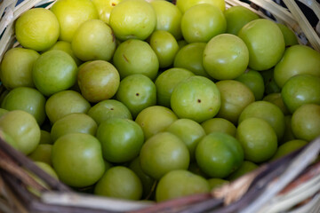Green turkish plum can erik in basket