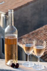 French cold rose dry wine from Provence in two glasses in sunny day with view on old roofs of Arles...
