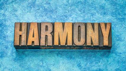 harmony word in vintage wood type against handmade blue paper, balance, order, symmetry and compatibility concept