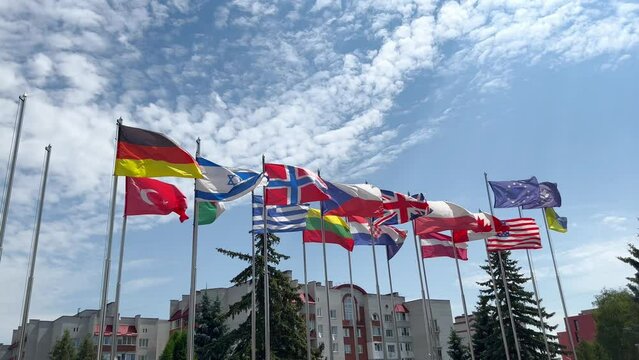 Flags of different countries, flags of the European Union, flags of America, Israel, Canada, Germany, Norway are waving in the wind. Flags of different countries of the world next to each other