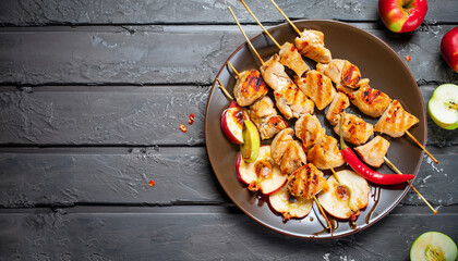 Chicken skewers with slices of apples and chili. Top view