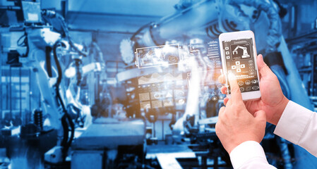 Digital future manufacture concept, Industrial Engineer working with automation robot arms machine  on real time monitoring system software.