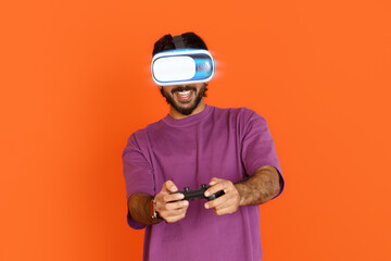 Smiling eastern young guy using VR glasses and joystick