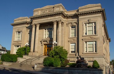 Fototapeta premium The Dalles, Oregon, USA - 24 June, 2023: Wasco County Courthouse Front Quarter View Looking Uphill with Blue Sky