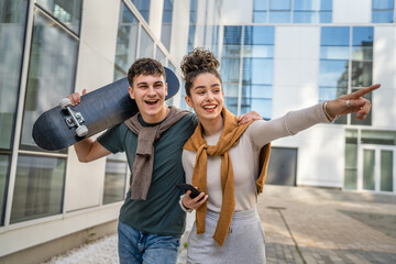 modern brother and sister or couple young man and woman walk outdoor