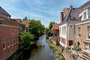 Fototapeta na wymiar Summer cityscape with architecture traditional canal houses, Appingedam is a city and former municipality in the northeastern Netherlands, The small town in Groningen known as The Venice of the North.