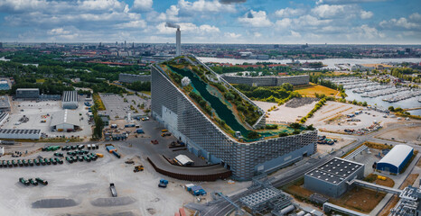 Amager Bakke, Amager Hill or Amager Slope or Copenhill - a heat and power waste-to-energy plant and a sports park in Amager, Copenhagen, Denmark. ESG green energy. - obrazy, fototapety, plakaty
