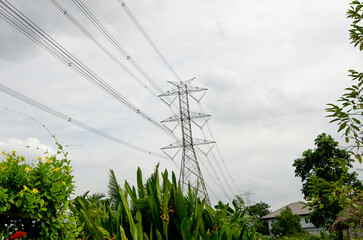 High electrical transmission line and pylon  powerful station with tree and blue sky background
