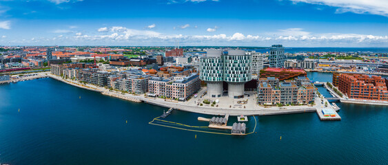 Aerial panorama of Indre Osterbro, Nordhavnen districts. New modern district in Copenhagen, Denmark. Beautiful modern buildings, Portland Towers and UN. - obrazy, fototapety, plakaty