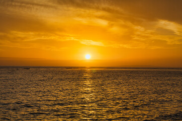 Fiery golden sky as sun sets on Maui.