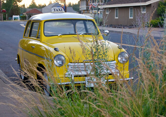 vintage yellow taxicab waiting for passengers
