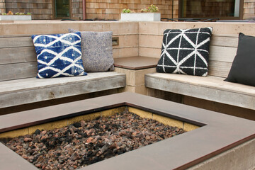 outdoor fire pit with lounge seats and pillows