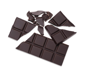 Pieces of delicious dark chocolate bar on white background, top view
