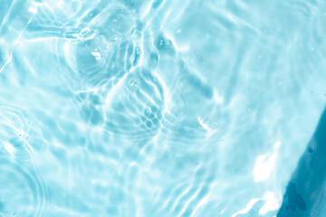 Closeup Transparent blue clear water surface texture with ripples. Abstract​ of​ surface​ blue​ splashes and bubbles​ water waves  reflected​ with​ sunlight​ for