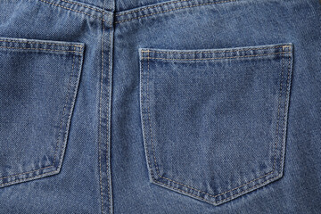 Jeans with pockets as background, top view
