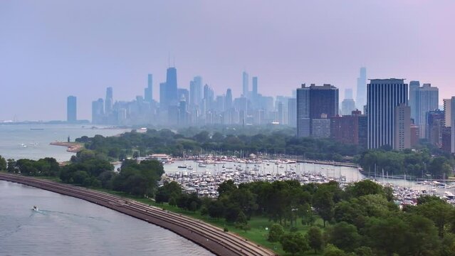 Aerial shot of Chicago, blue sky, lake Michigan, green park, yacht parking, 4k.