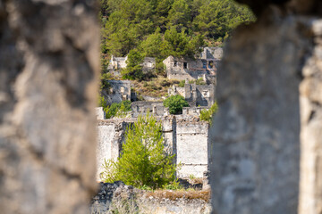 Window view of ancient Greek house ruins in the ghost town of Kayakoy. Kayakoy is abandoned Greek village in Fethiye district, Turkey.