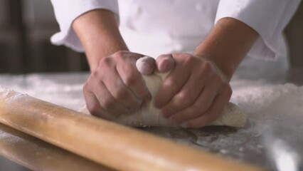 Hands kneading dough in pastry kitchen, Slow motion