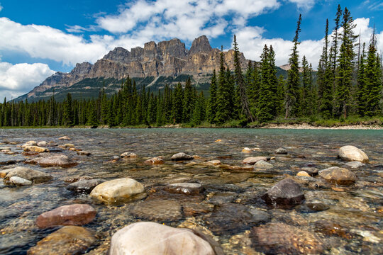 Summer time stunning views at Castle Mountain in Banff National Park with views along the turquoise Bow River in Alberta. Beautiful blue sky day with clouds. 