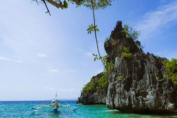 Tropical island rocks on a blue sea. Calatrava, Romblon, Philippines