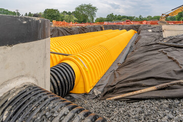 Yellow underground storm water detention mitigation units on a construction site ready to be...