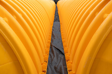 Yellow underground storm water detention mitigation units on a construction site ready to be...