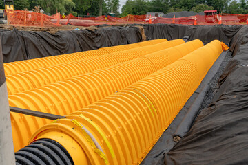 Yellow underground storm water detention mitigation units on a construction site ready to be...