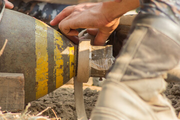 Soldier's hands defuse a bomb 500 lbs in war.