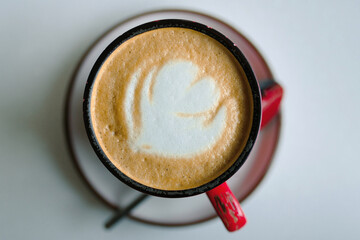 Top view of red cup of coffee, cappuccino drink to start the day.