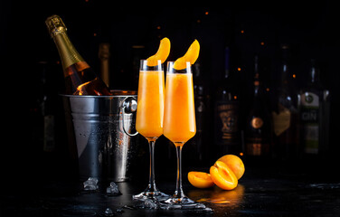 Apricot Bellini alcoholic cocktail drink with prosecco, cava, or sparkling wine with apricot puree,...