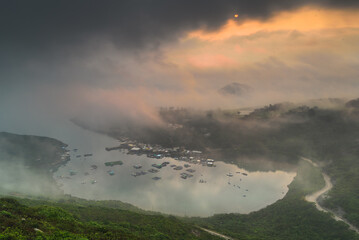 sunset over the mountains and clouds and lake