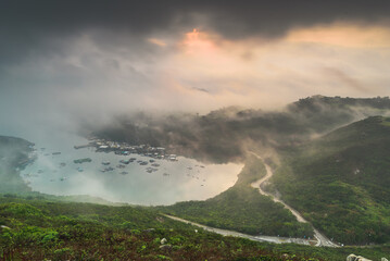 sunset over the mountains and clouds and lake