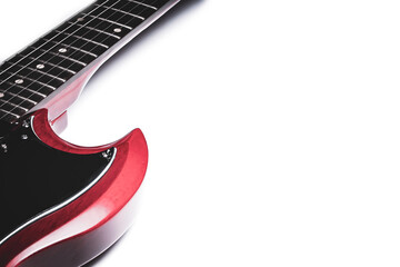 Cherry red electric guitar isolated on a white background with plenty of room for ad space.