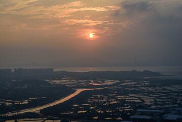 time clouds over the city at sunset