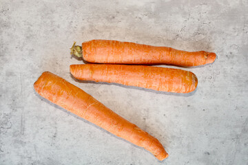 Top view of three whole raw carrots.