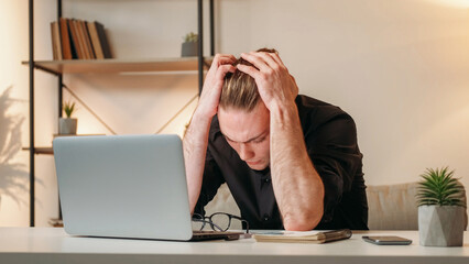 Professional fatigue. Tired employee. Exhausted business man suffering from headache clutching head...
