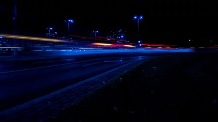  Lights of cars at night. Street line lights. Night highway city. Long exposure photograph night road. Colored bands of red light trails on the road. Background wallpaper defocused photo.  © anna.stasiia