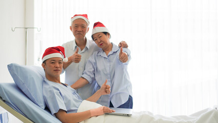 Asian family celebrating Christmas and New Year in hospital kid admit recovery good family...