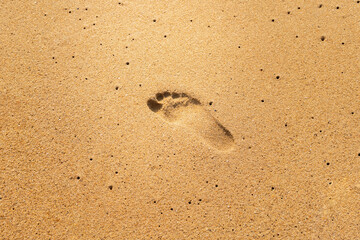 Close-up of footprint on sand in the summer time.