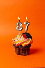 cupcake on orange background with birthday candles - birthday cake with number 0