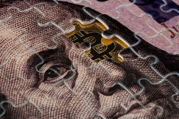 A fragment of a puzzle from a bill of 100 US dollars and a piece of a coin with the symbol of the...