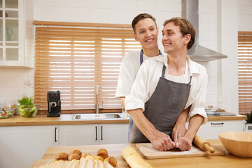 LGBT gay couple making a bread together in the kitchen