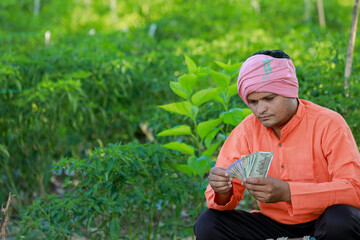 Happy Indian farmer, farmer holding indian rupees in hands, smart farming