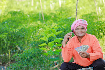 Happy Indian farmer, farmer holding indian rupees in hands, smart farming