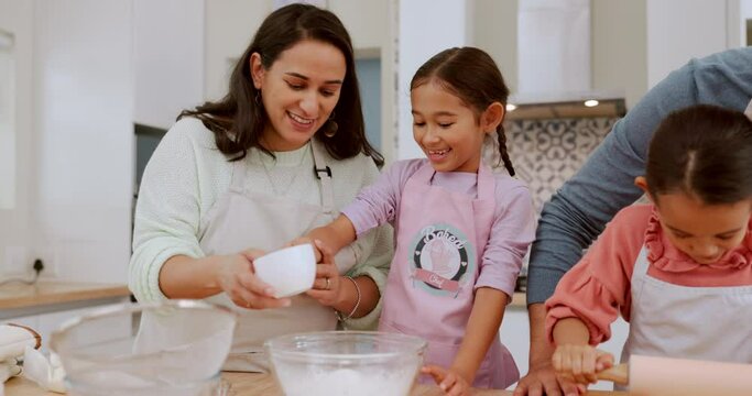 Kitchen, sugar and happy family children baking dessert, food or prepare recipe ingredients with help from mom, dad or parents. Teaching, cup and home father, mother and kids learning cooking skills
