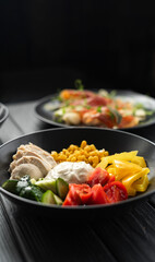 Chicken salad with cherry tomatoes, corn, cucumber and mayonnaise for mixing